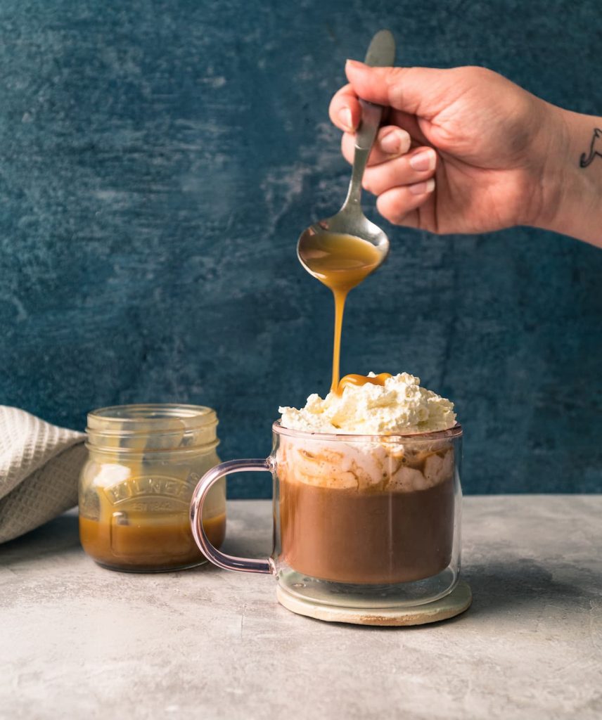 Butterscotch latte with smokey butterscotch sauce being poured over