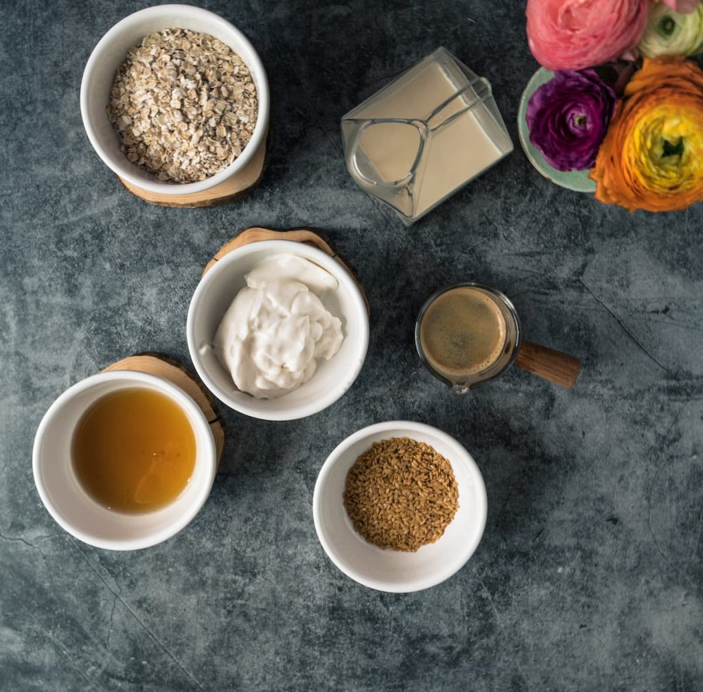 What you need for coffee overnight oats - oats, maple syrup. coconut yoghurt, flax seeds, coffee and plantbased milk.